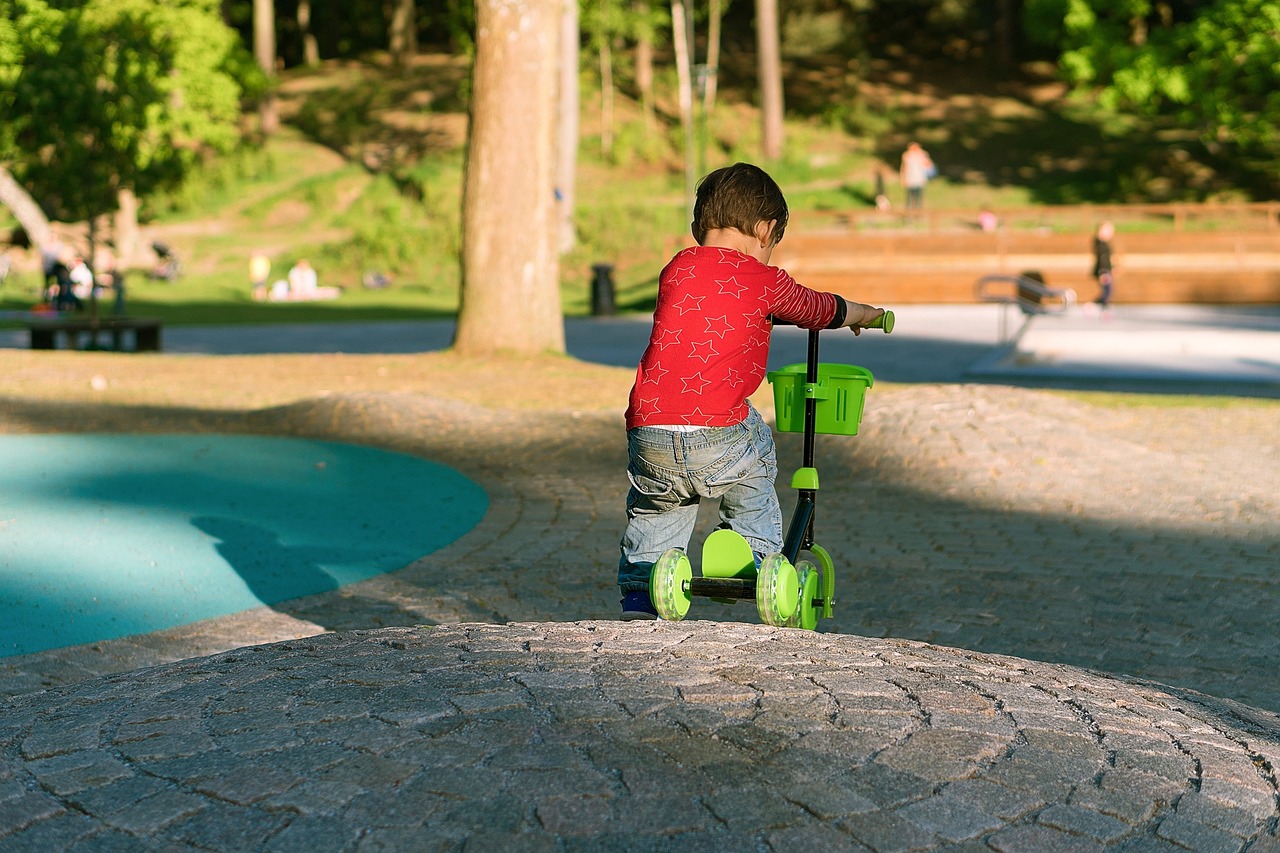 A kick scooter and a stunt scooter side by side