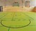 Sit-and-scoot boards stacked in a school gym